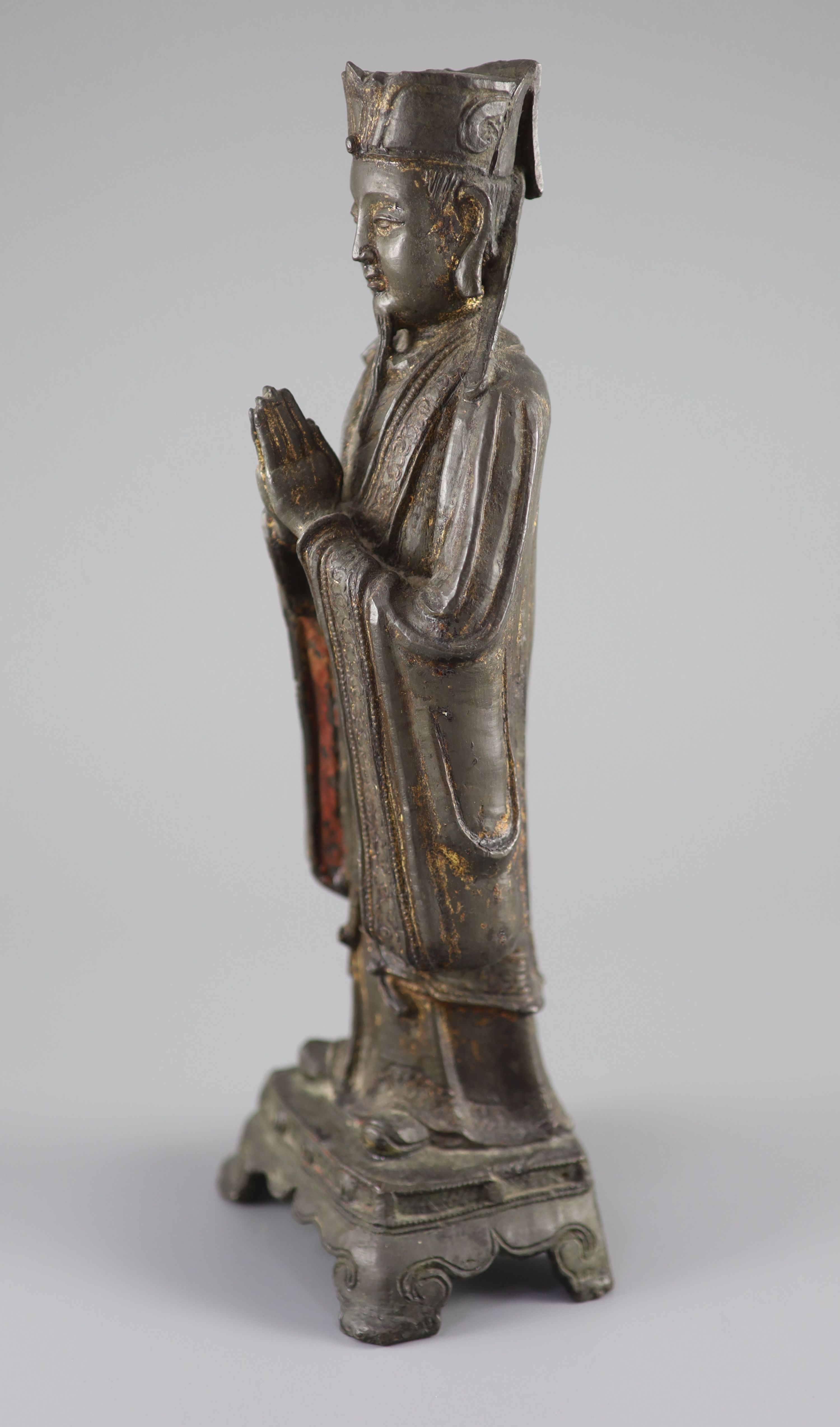 A Chinese bronze standing figure of an immortal, late Ming, 17th century, 31.3 cm high